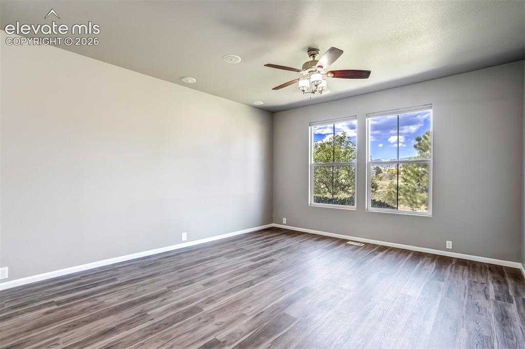 Image 9 of 50: Wood-finish flooring, recessed lighting, and a ceiling fan with light fixtu