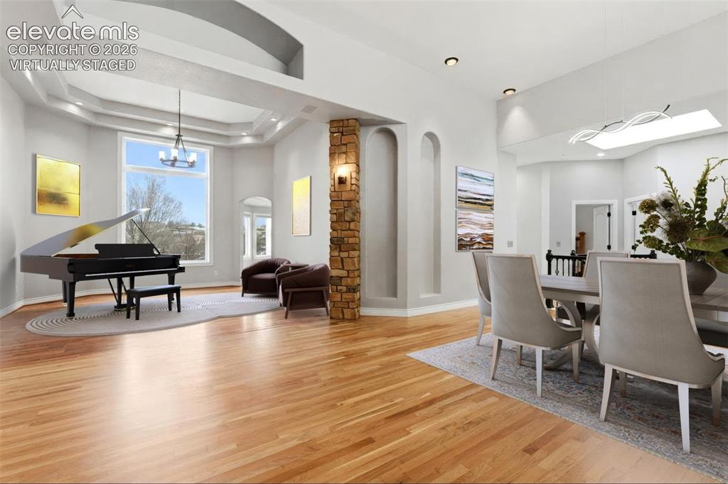 Image 12 of 46: Virtually staged. Hardwood flooring throughout, tray ceiling with recessed