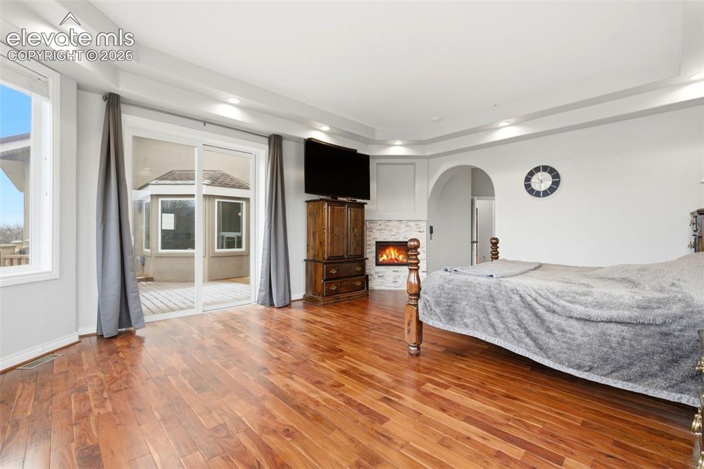 Image 22 of 46: Wood-finish flooring, recessed lighting, and tray ceiling