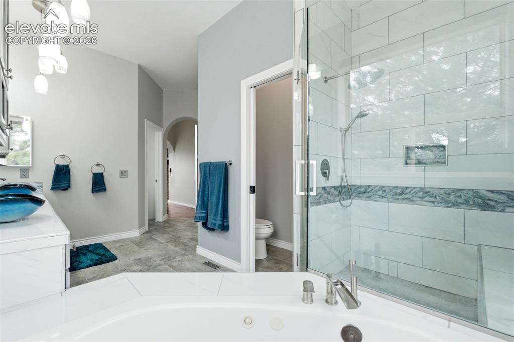 Image 25 of 46: Corner soaking tub with deck-mounted faucet