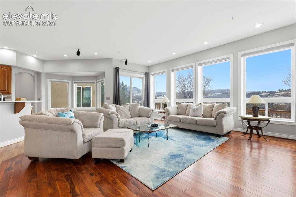 Image 3 of 46: Hardwood-finish flooring, recessed lighting, expansive windows, a sliding g