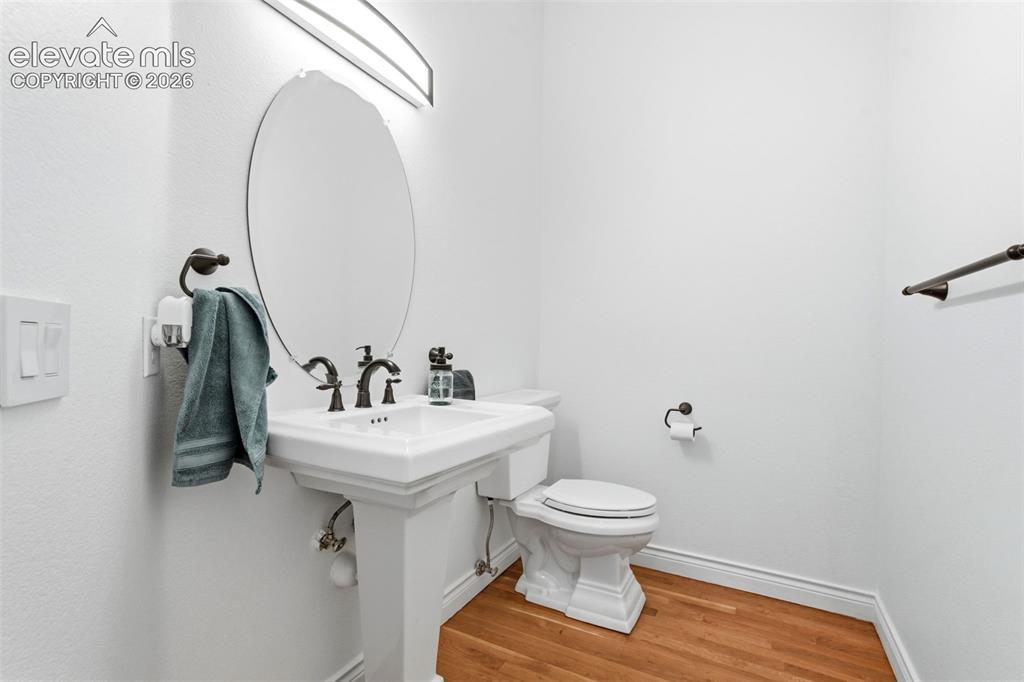 Image 31 of 46: Pedestal sink with oil-rubbed bronze fixtures, oval mirror, and a wall-moun
