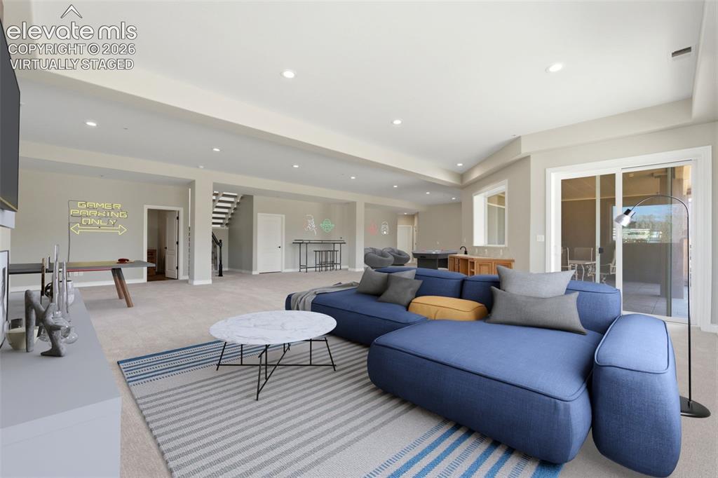 Image 32 of 46: Virtually staged. Spacious room with recessed lighting, sliding glass doors