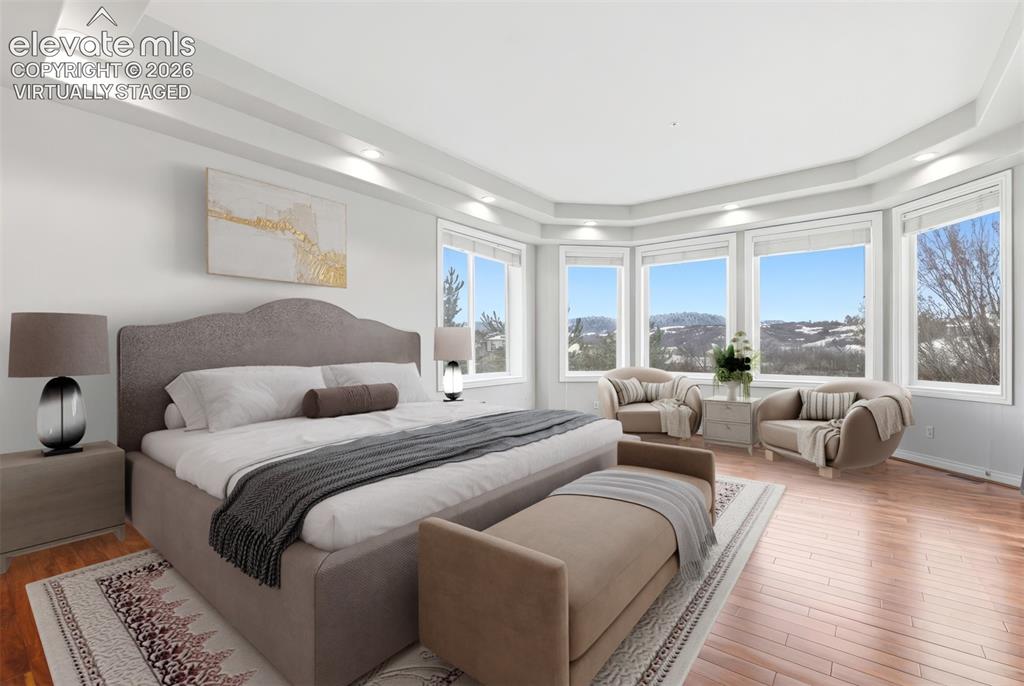 Image 4 of 46: Virtually staged. Hardwood flooring with a glossy finish, expansive bay win