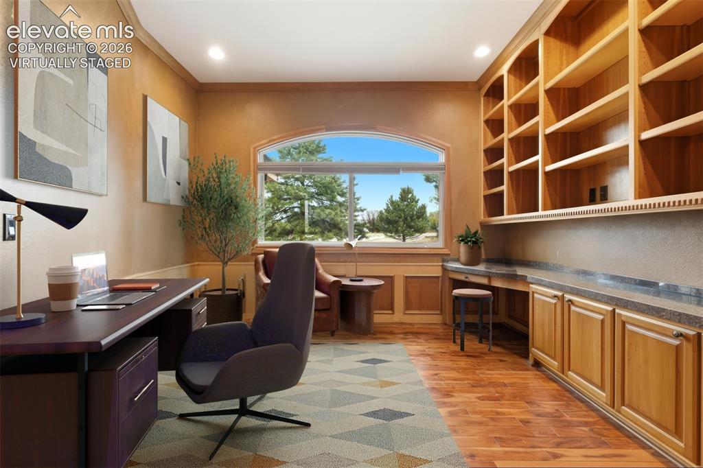 Image 9 of 46: Virtually staged. Built-in wood shelving and cabinetry, arched window, wood