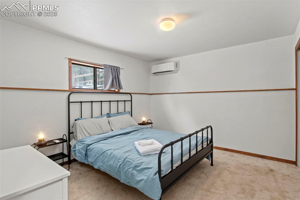 Image 24 of 50: Bedroom with light colored carpet and baseboards