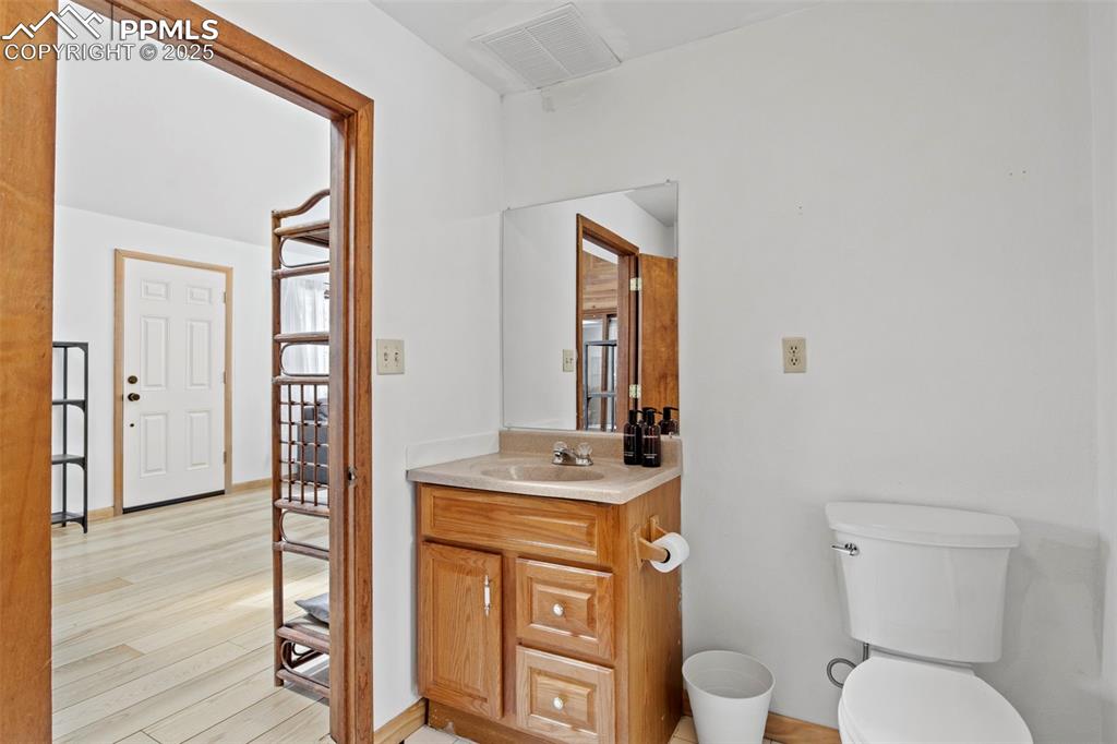 Image 30 of 50: Bathroom featuring vanity and light wood-type flooring