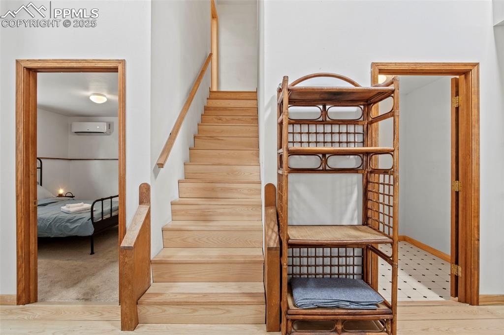 Image 31 of 50: Staircase featuring wood finished floors and baseboards