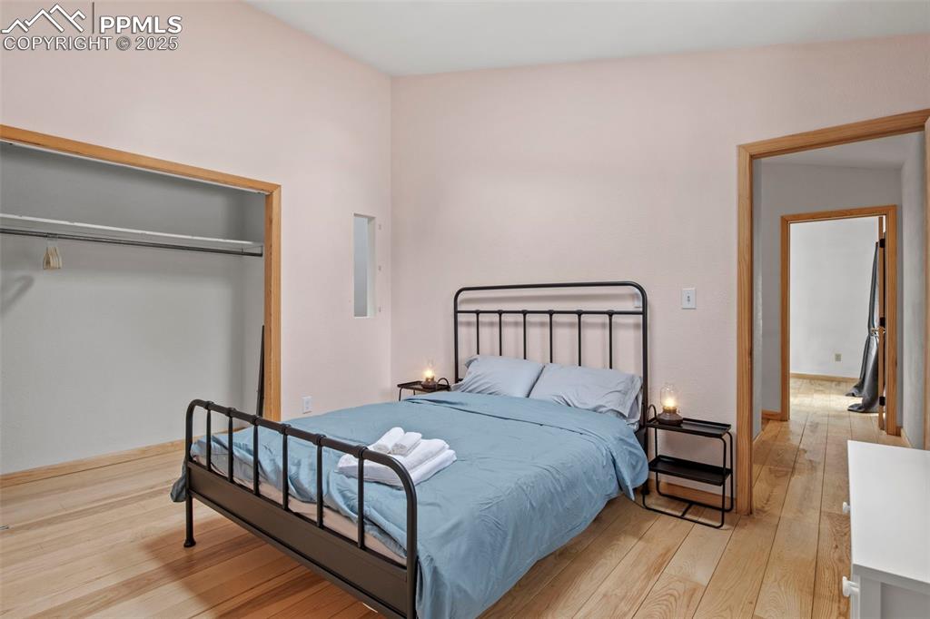 Image 40 of 50: Bedroom featuring light wood-style flooring