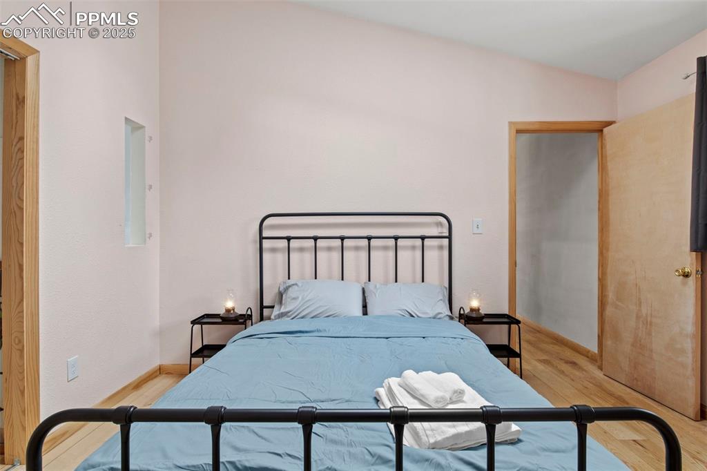 Image 41 of 50: Bedroom featuring light wood-style floors