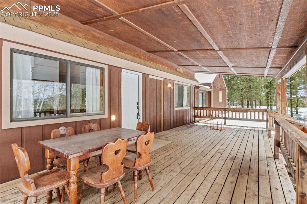 Image 46 of 50: Wooden deck featuring outdoor dining space