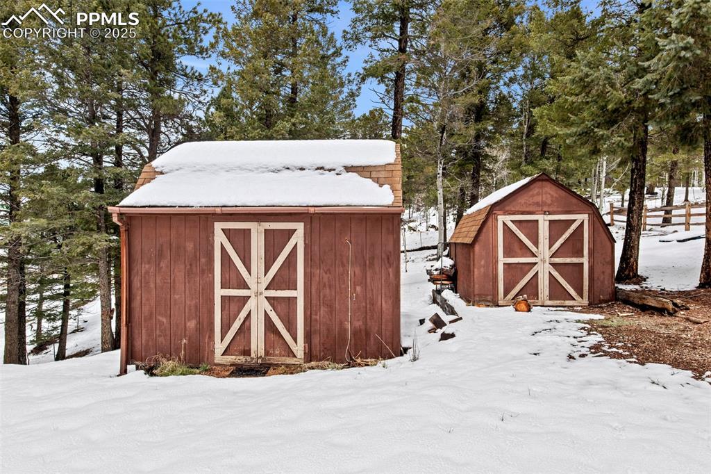 Image 48 of 50: Snow covered structure with a shed