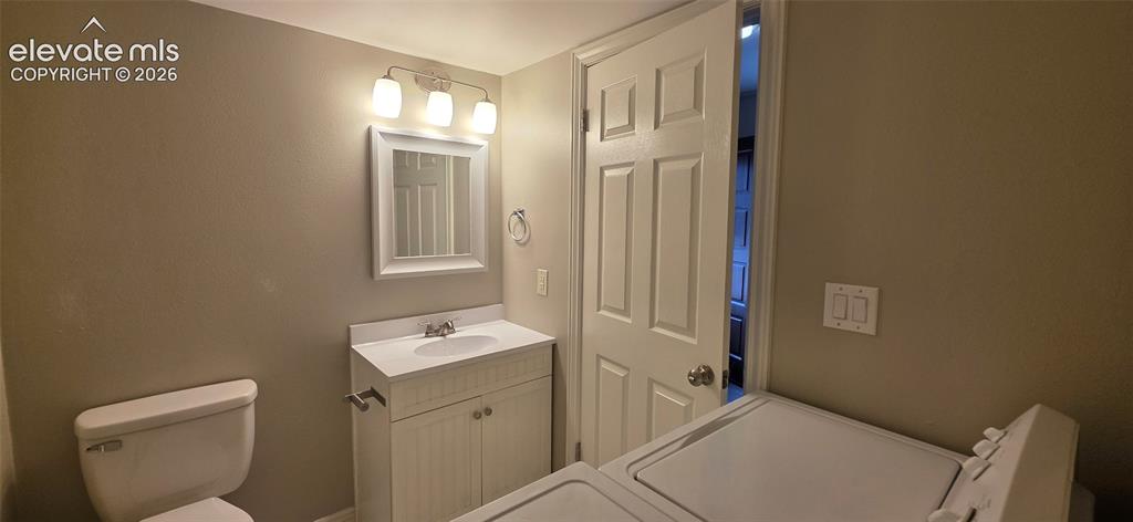 Image 17 of 44: Main level bathroom/laundry room