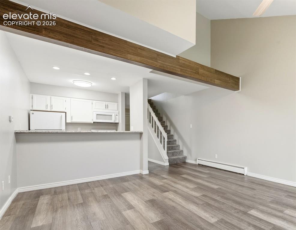 Image 7 of 44: Kitchen is open to dining/living room