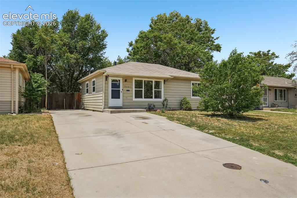 Image 1 of 34: Single-story exterior with light-colored siding, a front entry with a blue