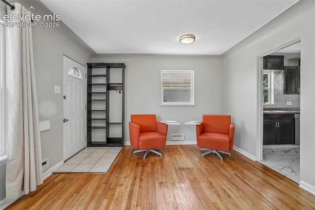 Image 7 of 34: Hardwood-finish flooring throughout, complemented by a tiled entry