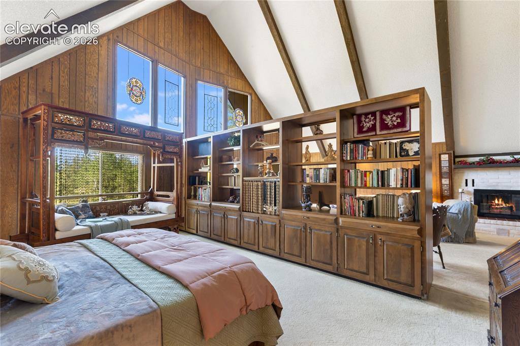 Image 18 of 33: The Primary bedroom is tucked behind a bookcase...I love creativity!