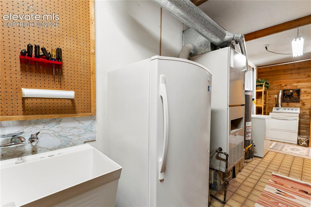 Image 21 of 33: And the Laundry room/storeroom connects the kitchen with the rec room