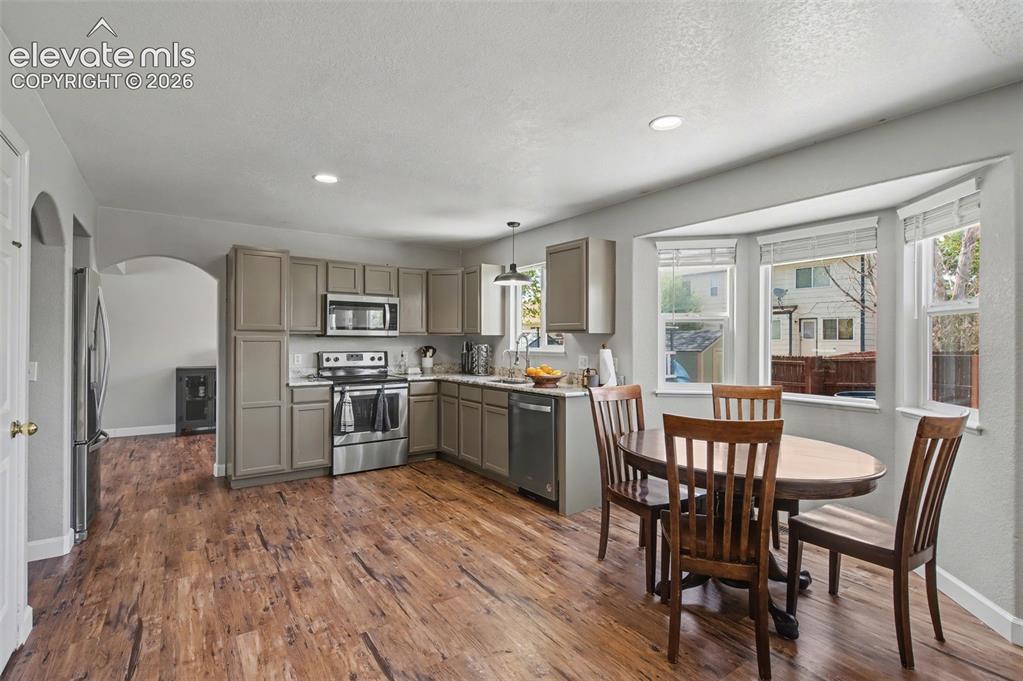 Image 13 of 37: Open-concept kitchen featuring wood-finish flooring, recessed lighting, and