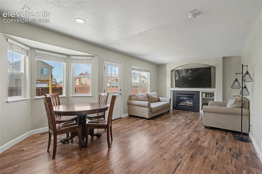 Image 16 of 37: Open-concept living area with wood-finish flooring
