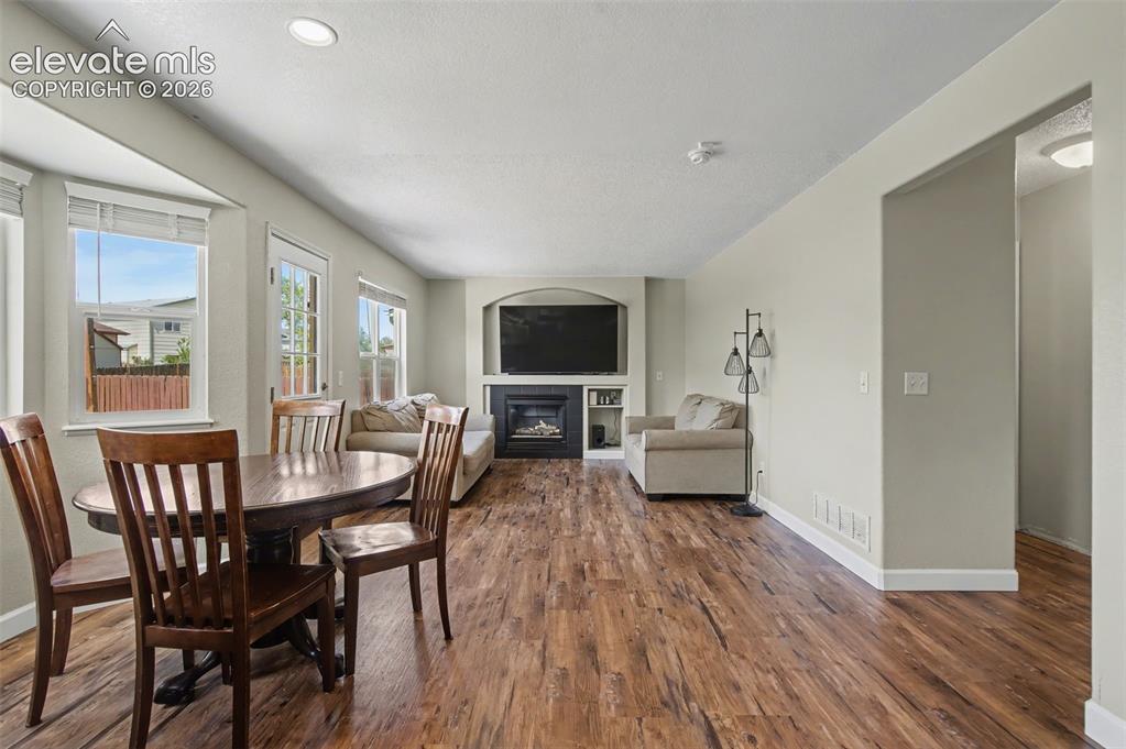 Image 17 of 37: Open-concept living area featuring wood-finish flooring, recessed lighting,