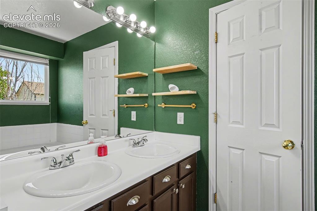 Image 22 of 37: Bathroom featuring a dual vanity with white countertops, chrome fixtures, a