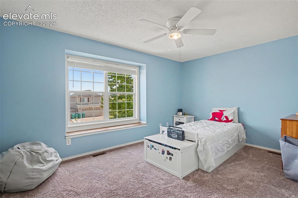 Image 25 of 37: Carpeted interior space featuring a large window with white blinds, a ceili