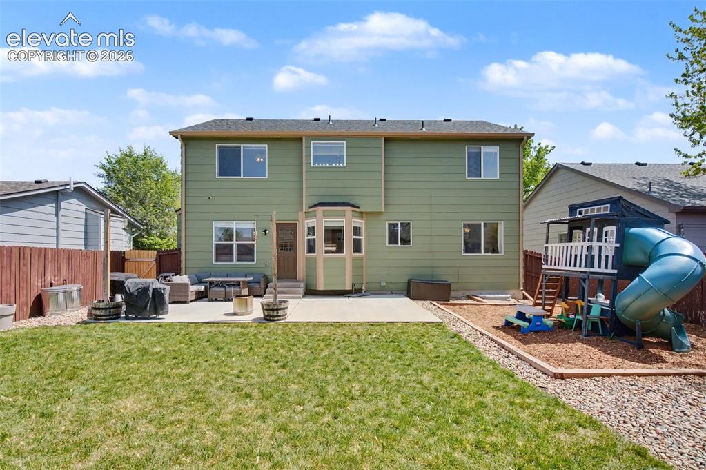 Image 35 of 37: Green-hued exterior featuring multiple windows and a bay window extension