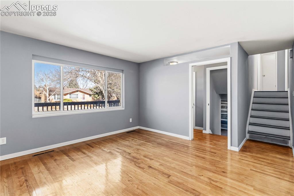 Image 10 of 42: Stairs lead to the primary bedroom and two additional bedrooms. 