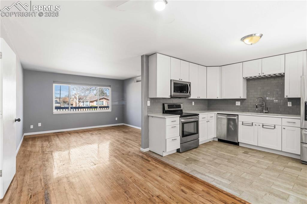 Image 11 of 42: Kitchen, dining room, living room