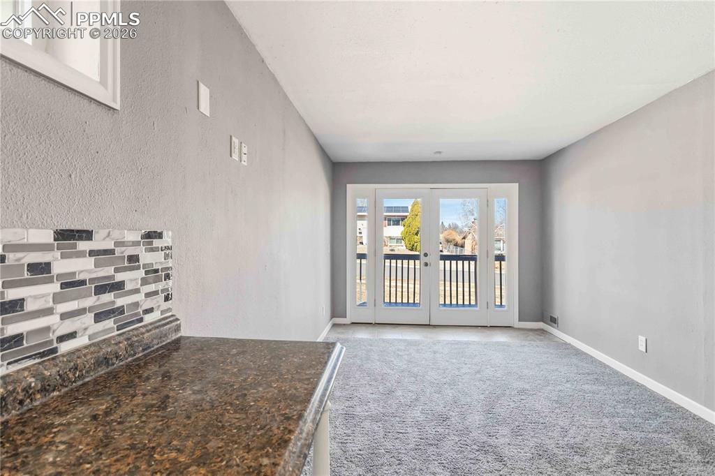 Image 32 of 42: Bonus room, new carpet, double doors to exterior