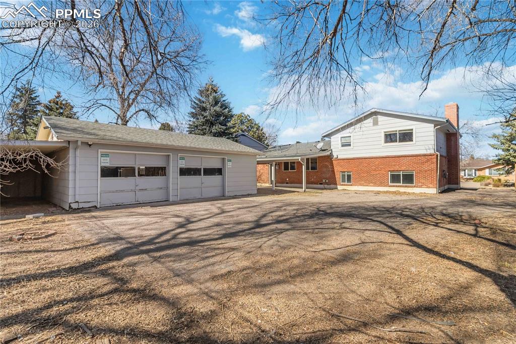 Image 36 of 42: 2 car garage and a carport 
