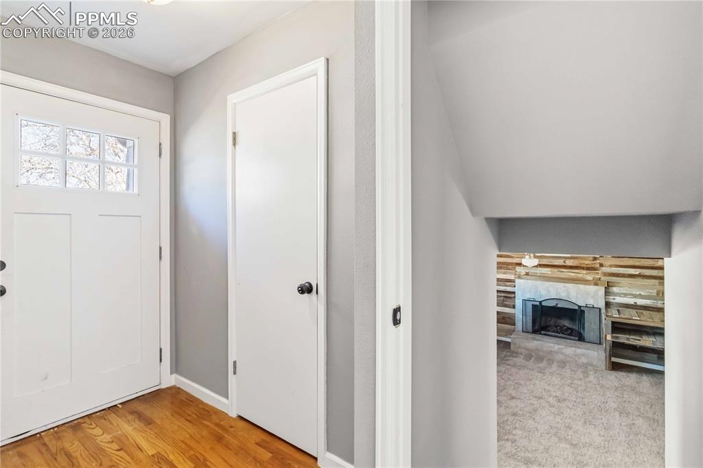 Image 5 of 42: Basement off entryway has a living room, bedroom, kitchenette, and bathroom