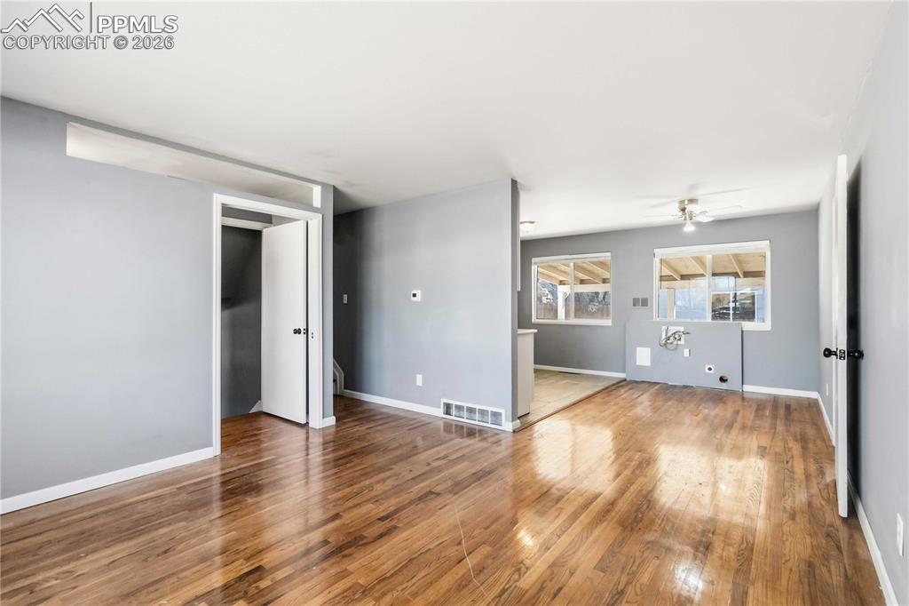 Image 6 of 42: Living room off entryway flows to dining area and kitchen.