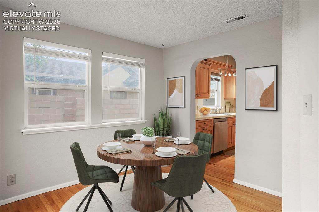 Image 12 of 29: Dining nook has hardwood floors and walk-out to the back patio! (Virtually 