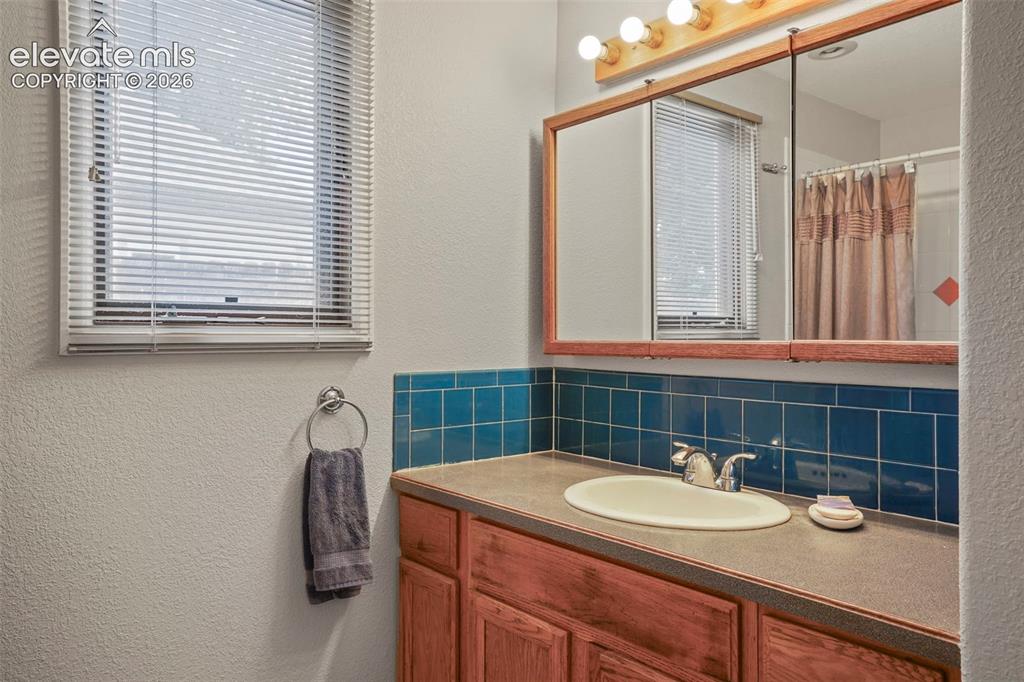 Image 17 of 29: Full Bath off the kitchen