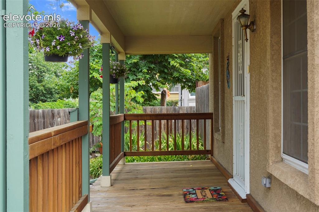 Image 3 of 29: The charming front porch welcomes you in.
