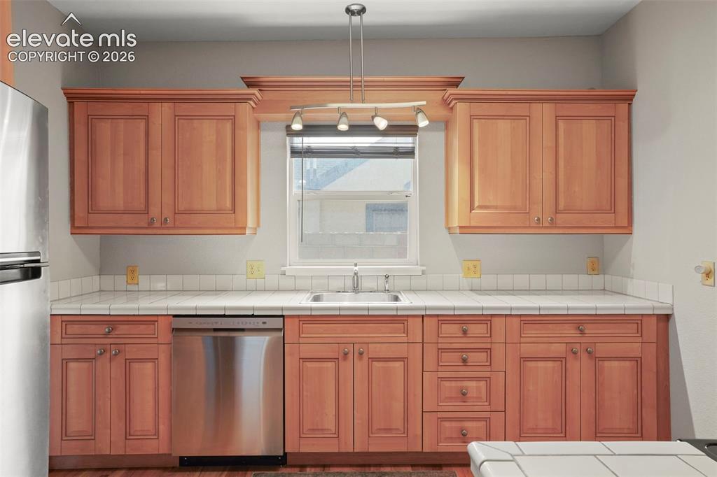 Image 9 of 29: Adorable kitchen has plenty of counter space and storage!