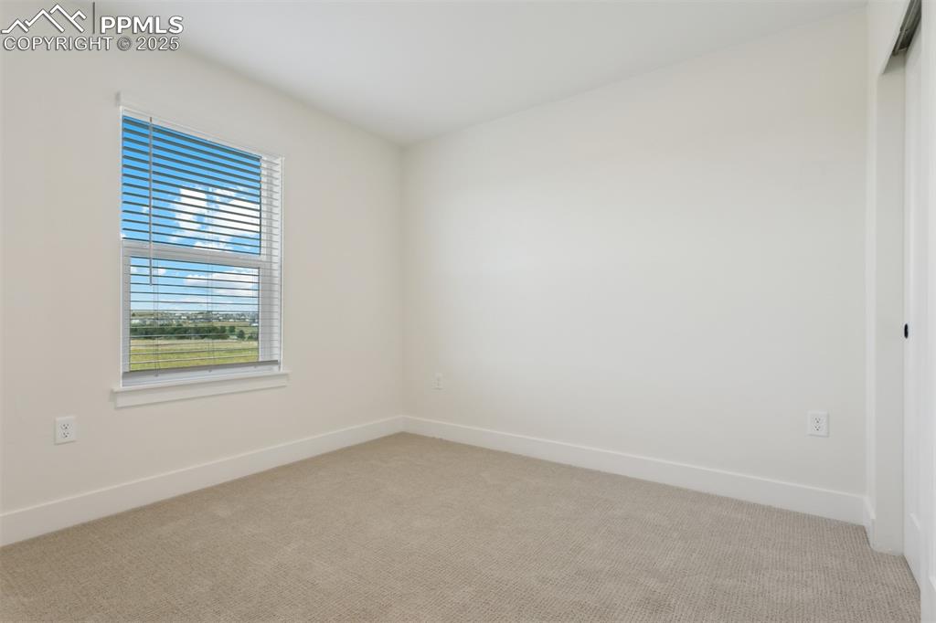 Image 10 of 19: Spare room with light colored carpet and baseboards