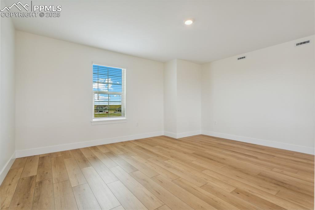 Image 4 of 19: Unfurnished room with baseboards, light wood-style flooring, and visible ve