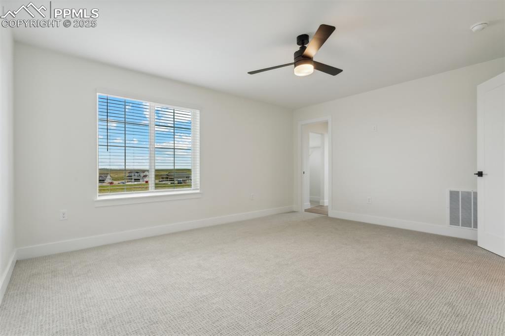 Image 5 of 19: Spare room with a ceiling fan, light carpet, baseboards, and visible vents