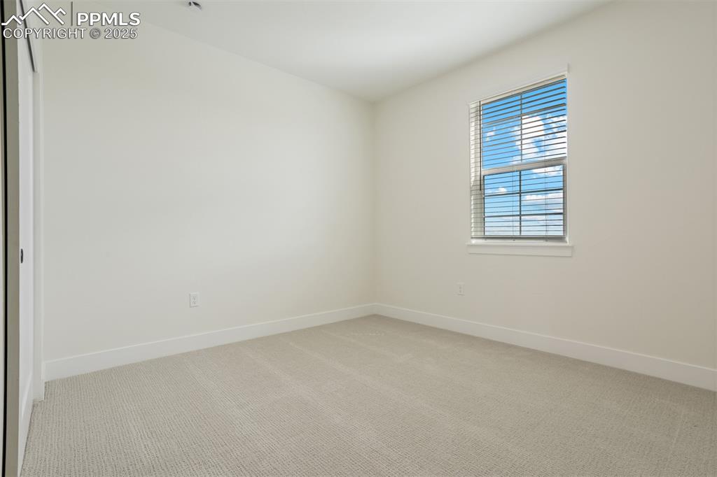 Image 8 of 19: Spare room with light carpet and baseboards