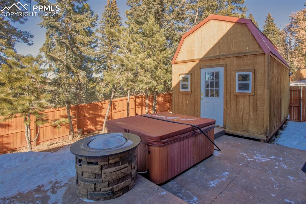Image 32 of 50: Back yard, hot tub and storage shed