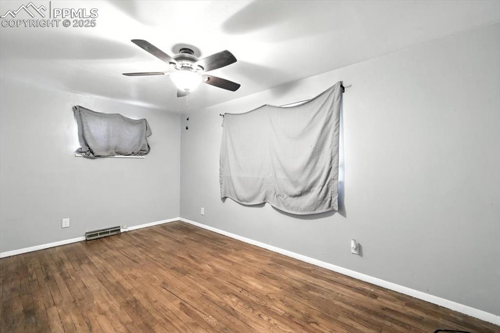 Image 19 of 30: Unfurnished room featuring ceiling fan and wood finished floors