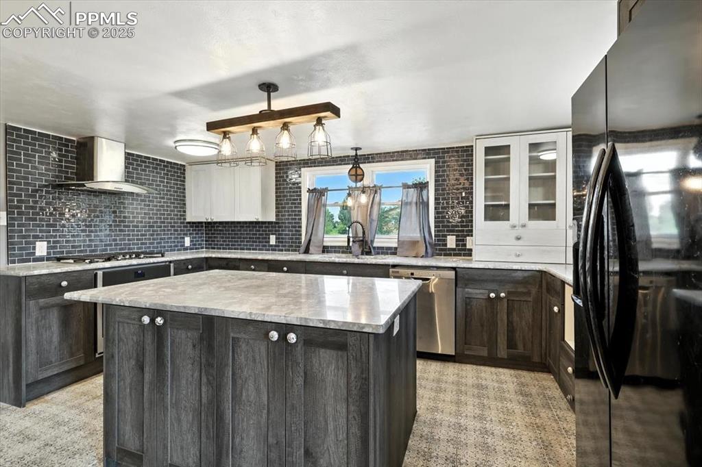 Image 8 of 30: Kitchen with stainless steel appliances, wall chimney exhaust hood, a kitch