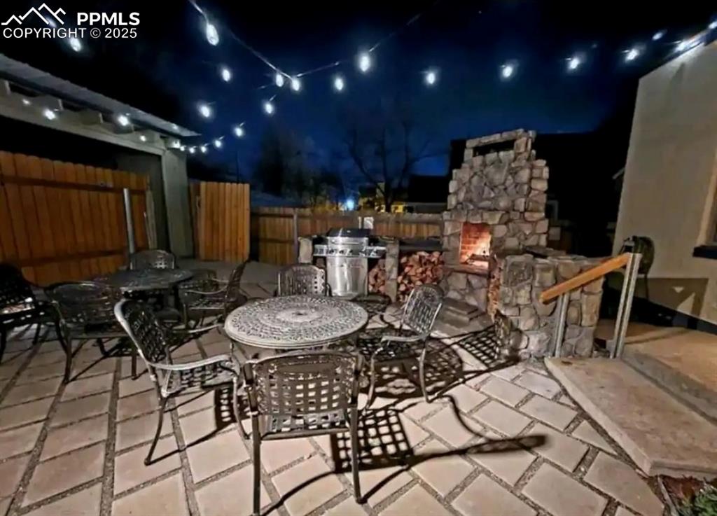 Image 3 of 16: Patio at twilight with outdoor dining area, a patio area, and area for gril