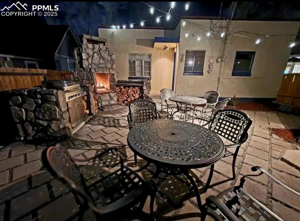 Image 4 of 16: View of patio featuring outdoor dining space and exterior kitchen
