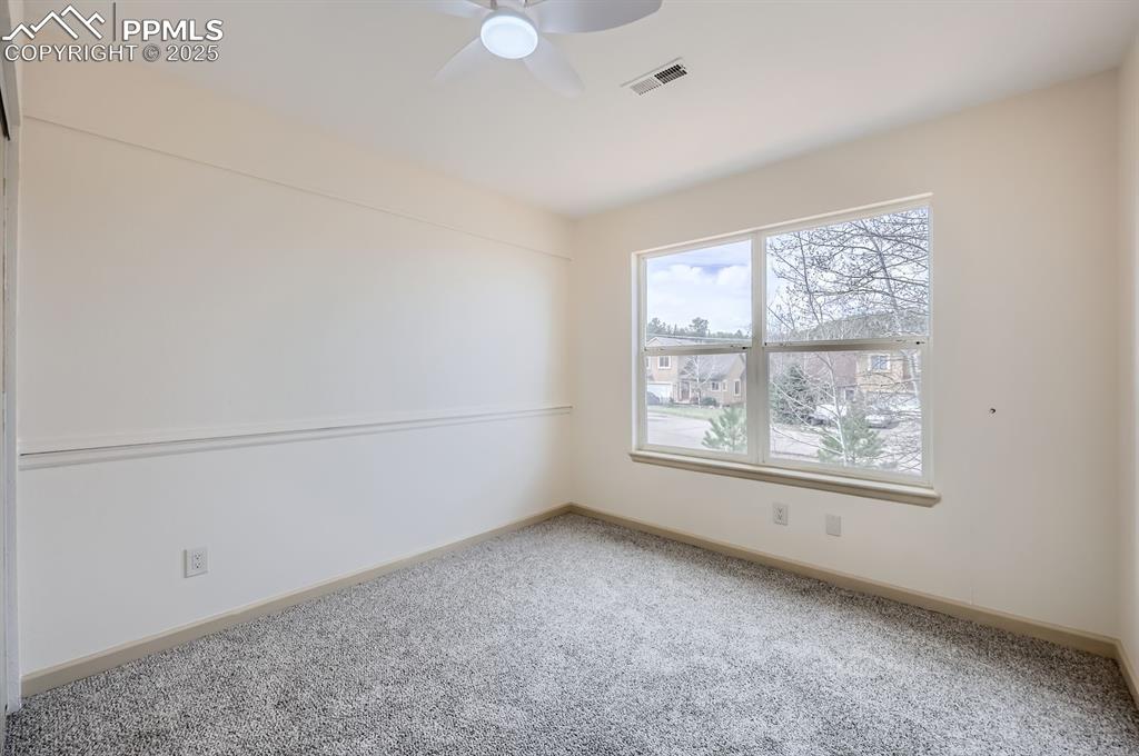 Image 20 of 31: Carpeted spare room with ceiling fan, baseboards, and visible vents