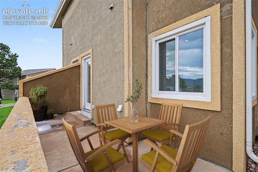 Image 20 of 30: Virtually staged walk-out patio from living room, with mountain views