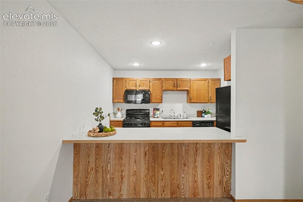 Image 8 of 30: Breakfast bar, where kitchen opens to dining and living areas